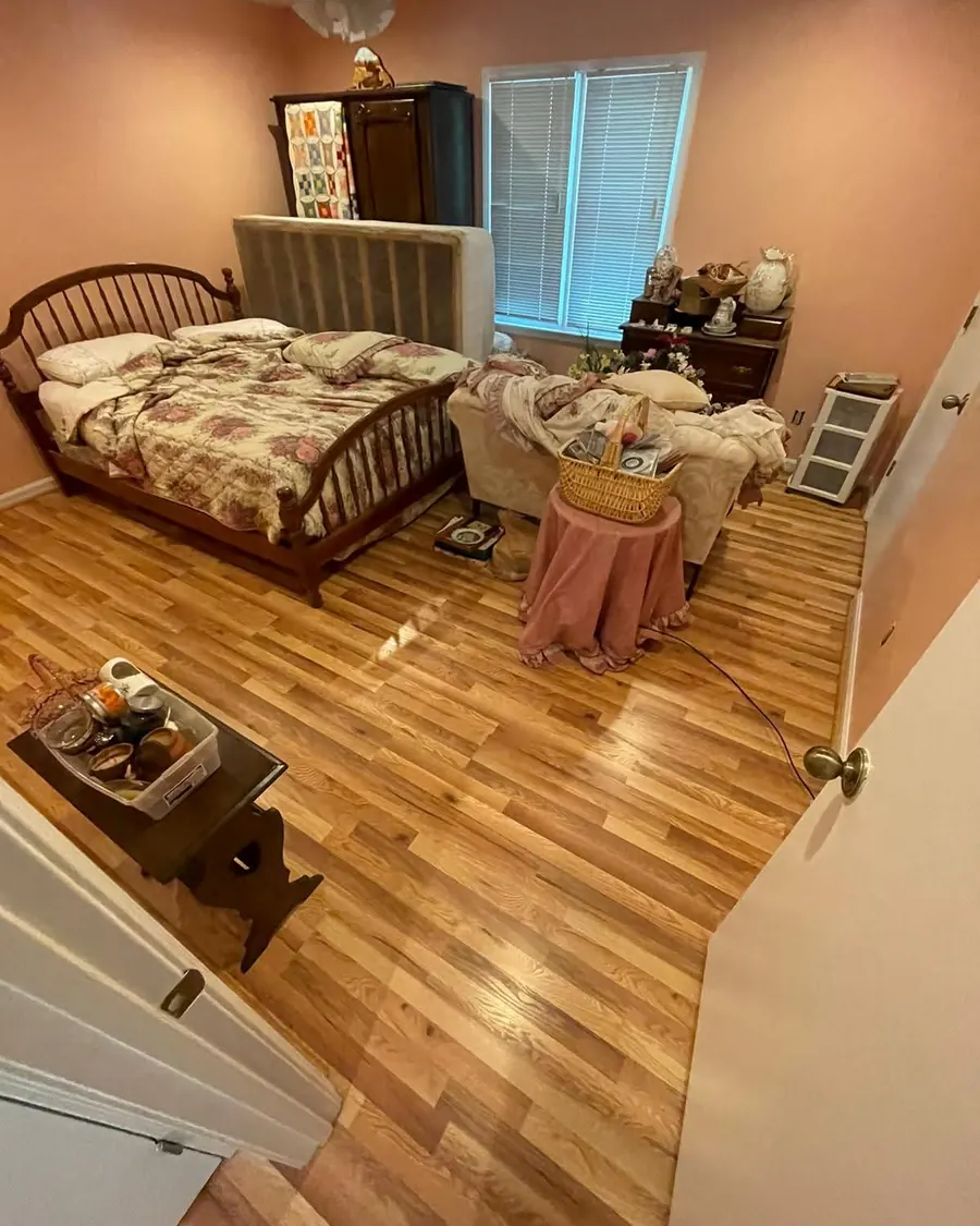 The same bedroom with new wood-look porcelain plank flooring