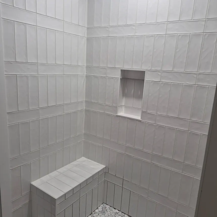 Subway tile shower with a built-in bench