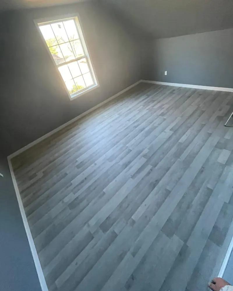 Grey wood-look porcelain plank across an upstairs bedroom