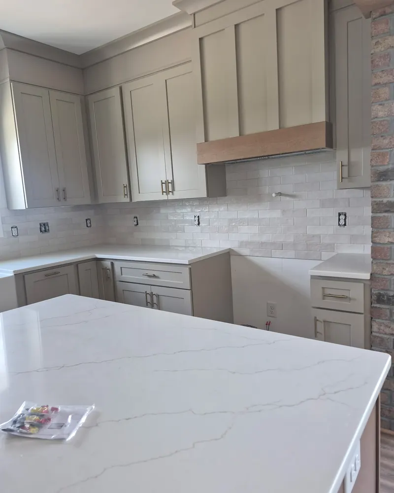 Kitchen backsplash with a quartz island in the foreground