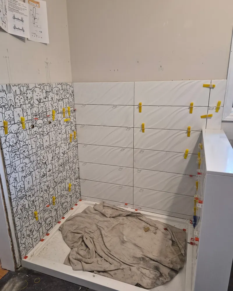 Backsplash mid-install with levelling clips still fitted