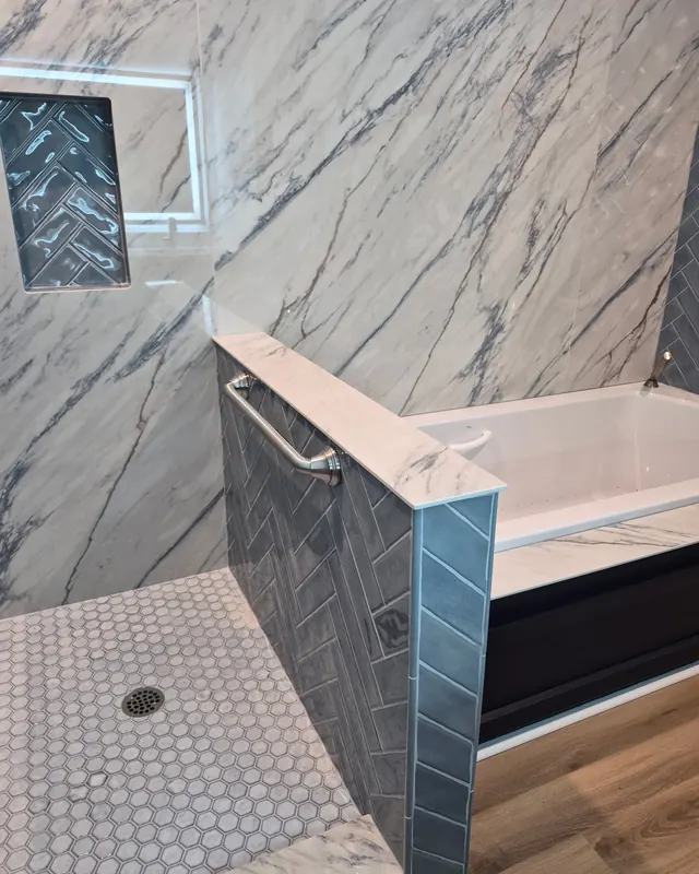 Book-matched marble tub surround with a penny-round floor